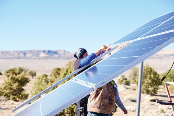 Phot of people near solar panels